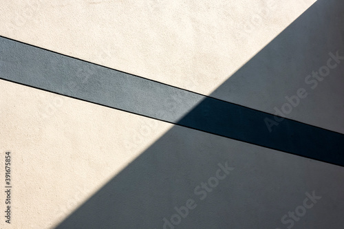 background with texture. Abstract Detail Of Contemporary Building Concrete Wall, With Bright Sunlight And Hard Shadow, X Shape, Religious Cross, Backgrounds, Textures. Stock Photograph.