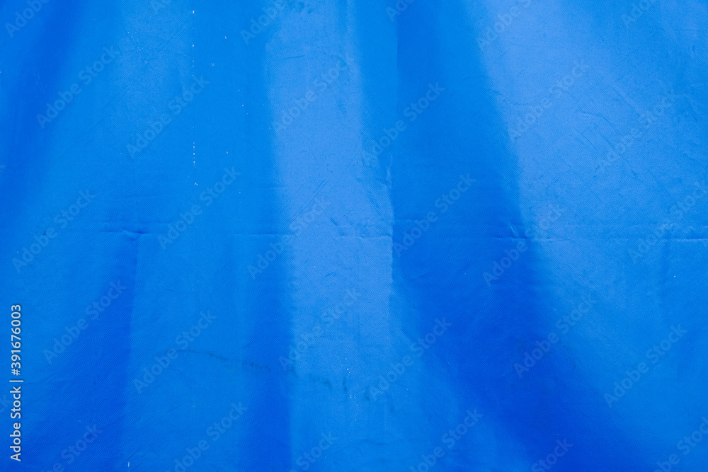 blue background. Minimalist Detail Of Blue Tarpaulin With Dappled