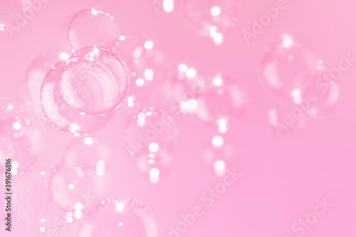 Beautiful shiny transparent soap bubbles float on pink background. Abstract, Celebration, Natual fresh summer, Chrimas holiday background.