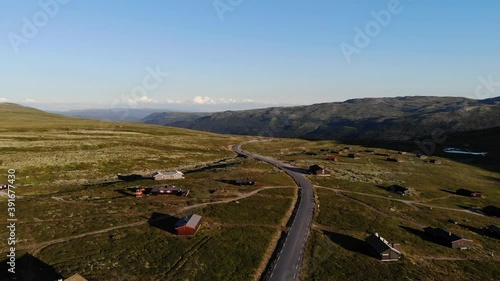 Mountain road and mountain cabins along it. Southern Norway, zooming out drone footage photo