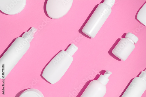 Mock up pattern for branding on pink background. Tubes, dispensers and jars. Cosmetics and dietary supplements for beauty and health. Flat lay