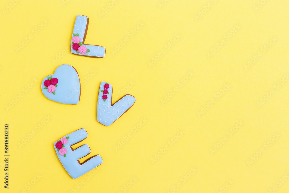 Painted gingerbread in shape of word love. Postcard minimal style for Valentines Day, wedding. Love romance concept. Top view with space for your text. Painted gingerbread in shape of word love. Postcard minimal style for Valentines Day, wedding. Love romance concept. Top view with space for your text.