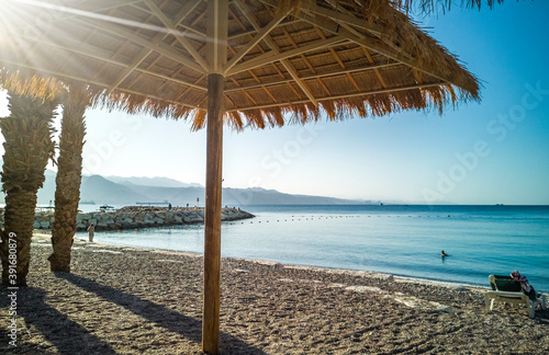 Fototapeta Naklejka Na Ścianę i Meble -  Sandy beach with umbrella or sunshade, Red Sea, Middle East