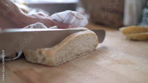 Wallpaper Mural Close up of a slice of white bread being cut from a loaf on a wooden cutting board. Slow motion with shallow depth of field.  Torontodigital.ca