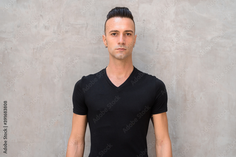 Portrait of handsome young Italian man with undercut wearing black t-shirt Portrait of handsome young Italian man with undercut wearing black t-shirt