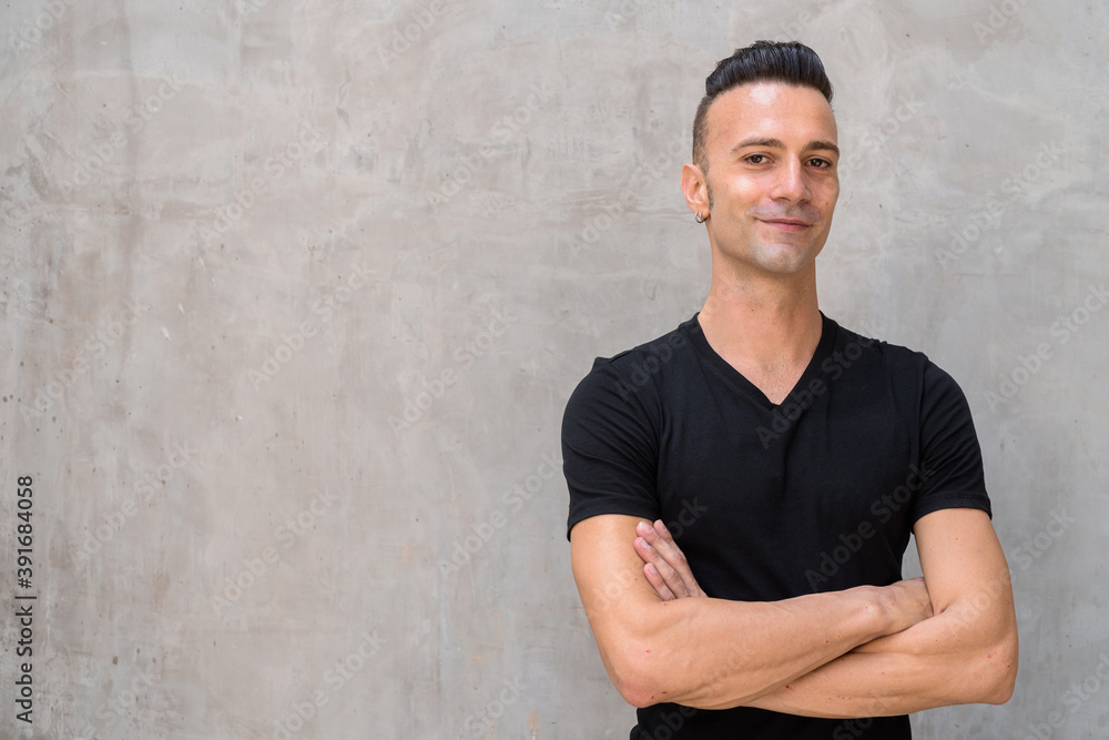 Portrait of happy young Italian man with undercut wearing black t-shirt Portrait of happy young Italian man with undercut wearing black t-shirt