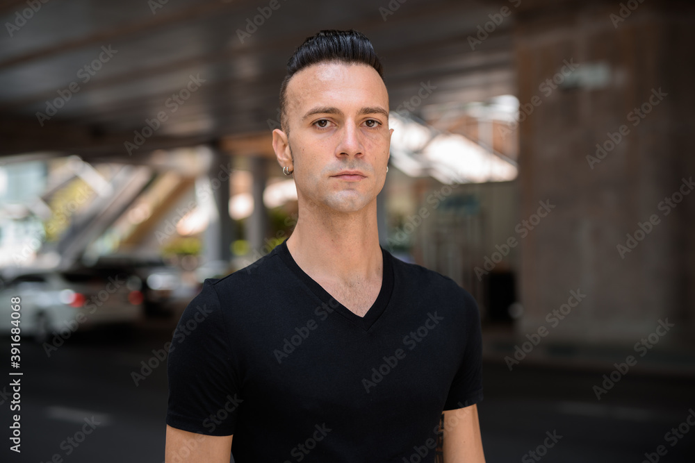 Portrait of handsome young Italian man face outdoors Portrait of handsome young Italian man face outdoors