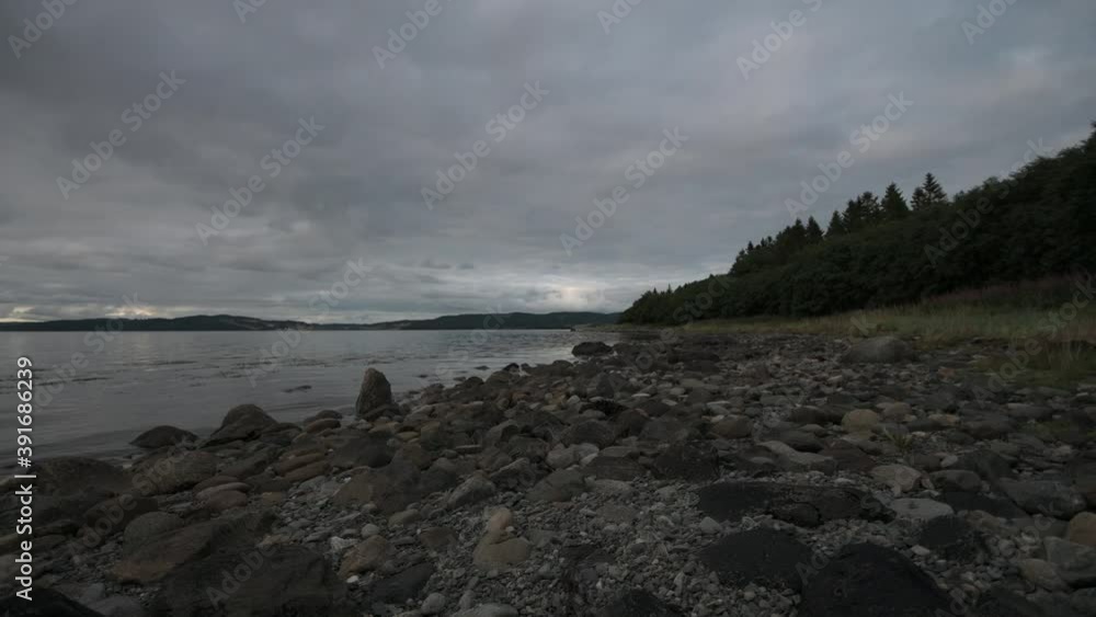 Water waves slowly washing near rocky beach Water waves slowly washing near rocky beach