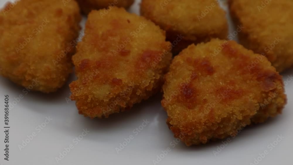 Baked crispy chicken nuggets on white plate Baked crispy chicken nuggets on white plate