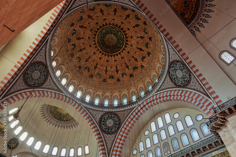 The interior of the mosque. The inner surface of domes and arches is painted in gold, silver, burgundy tones, decorated with ornaments. Along the perimeter of the window. Turkey