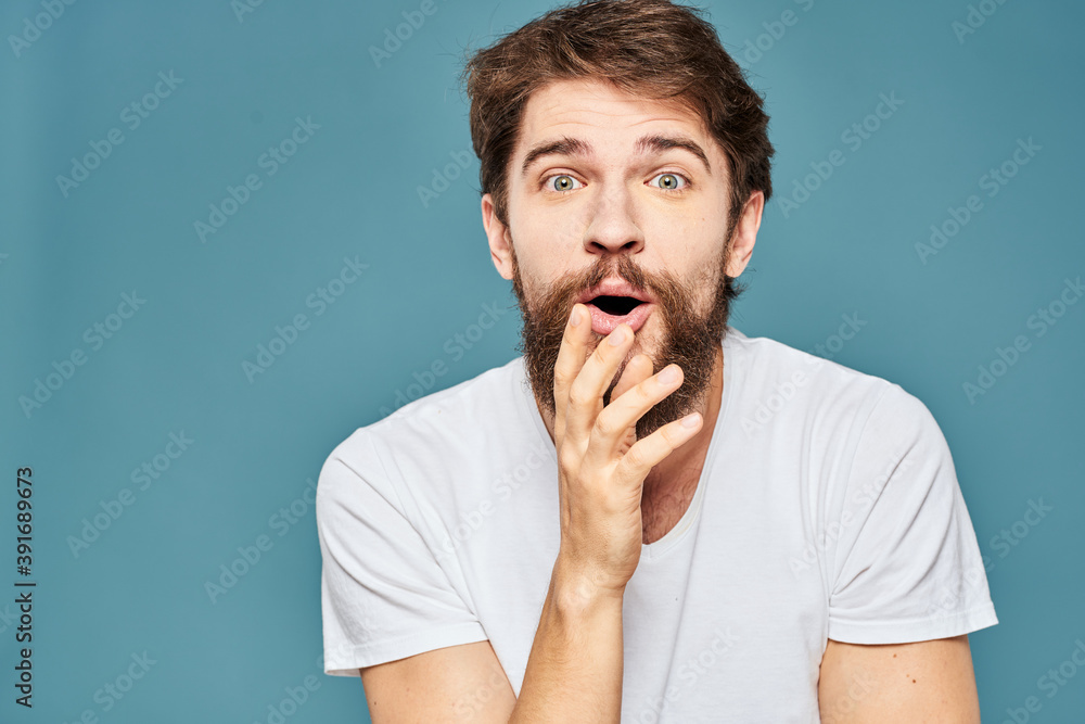 emotional man gesturing with hands lifestyle fun white t-shirt blue isolated stock emotional man gesturing with hands lifestyle fun white t-shirt blue isolated stock