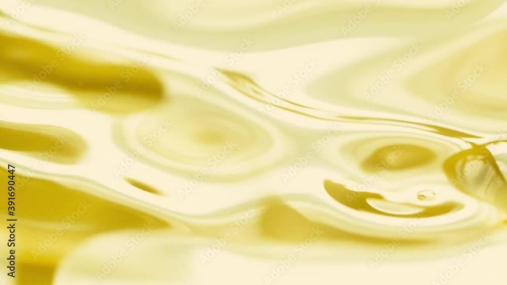 Close-up pouring golden olive oil liquid in slow motion, healthy food background Close-up pouring golden olive oil liquid in slow motion, healthy food background