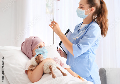 Nurse and little girl under...