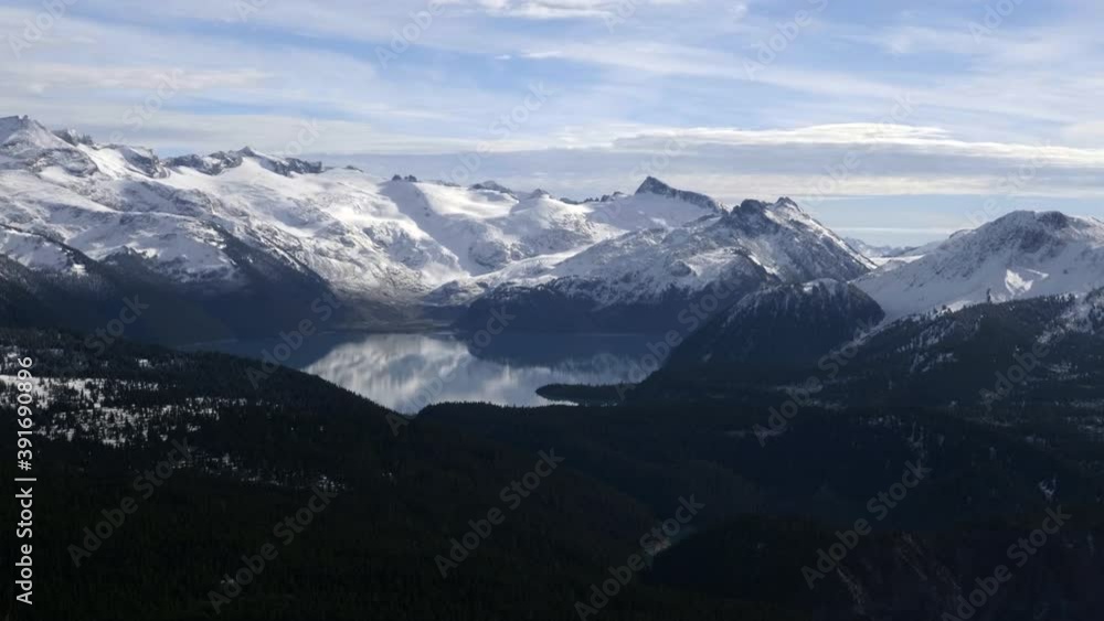 Beautiful snowy white mountains by the lake in Whistler, Canada -aerial Beautiful snowy white mountains by the lake in Whistler, Canada -aerial