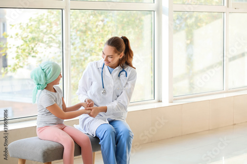 Doctor and little girl in clinic. Childhood cancer awareness concept