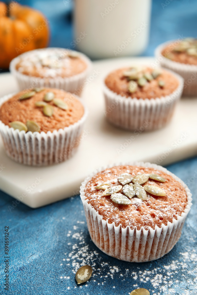 Tasty pumpkin muffins on color background Tasty pumpkin muffins on color background