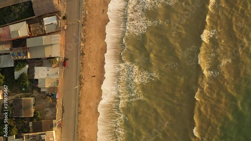 Aerial evening sunset drone shot of beach and waves. Evening scenery over Townsvillle from Crucita, Ecuador. Sunset Aerial view. photo