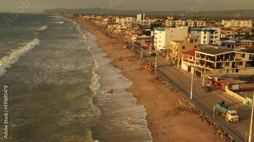 Aerial evening sunset drone shot of coastline town. Evening scenery over Townsvillle from Crucita, Ecuador. Sunset Aerial view. photo