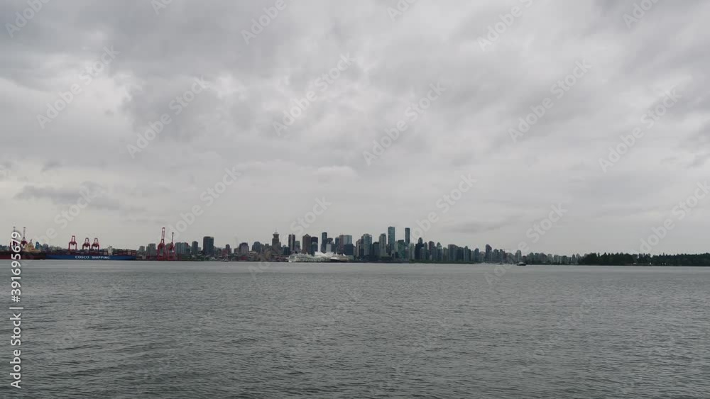 Drone shot flying towards downtown Vancouver over the harbour in moody weather Drone shot flying towards downtown Vancouver over the harbour in moody weather