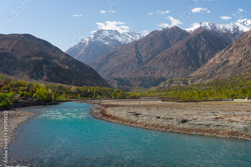 Beautiful blue river of Ghizer view from Ghizer valley surrounded by Hindu Gush mountains range  North Pakistan