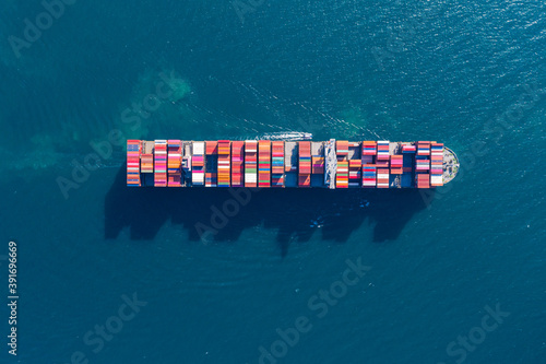 Cargo container in factory harbor at industrial estate for import export around in the world, Trade Port / Shipping - cargo to harbor. Aerial view of sea freight, Cargo ship, 