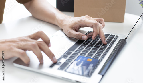 Men use smart phone to register online purchases using credit card payments.