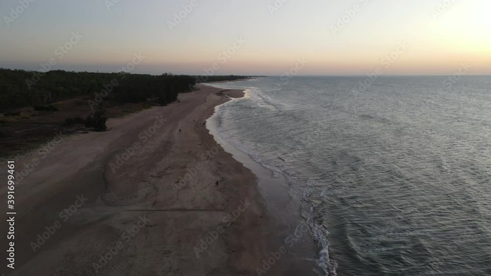 Slow Moving Drone shot of Orange Sunset and People walking on Lee Point Beach in Darwin, Northern Territory Slow Moving Drone shot of Orange Sunset and People walking on Lee Point Beach in Darwin, Northern Territory