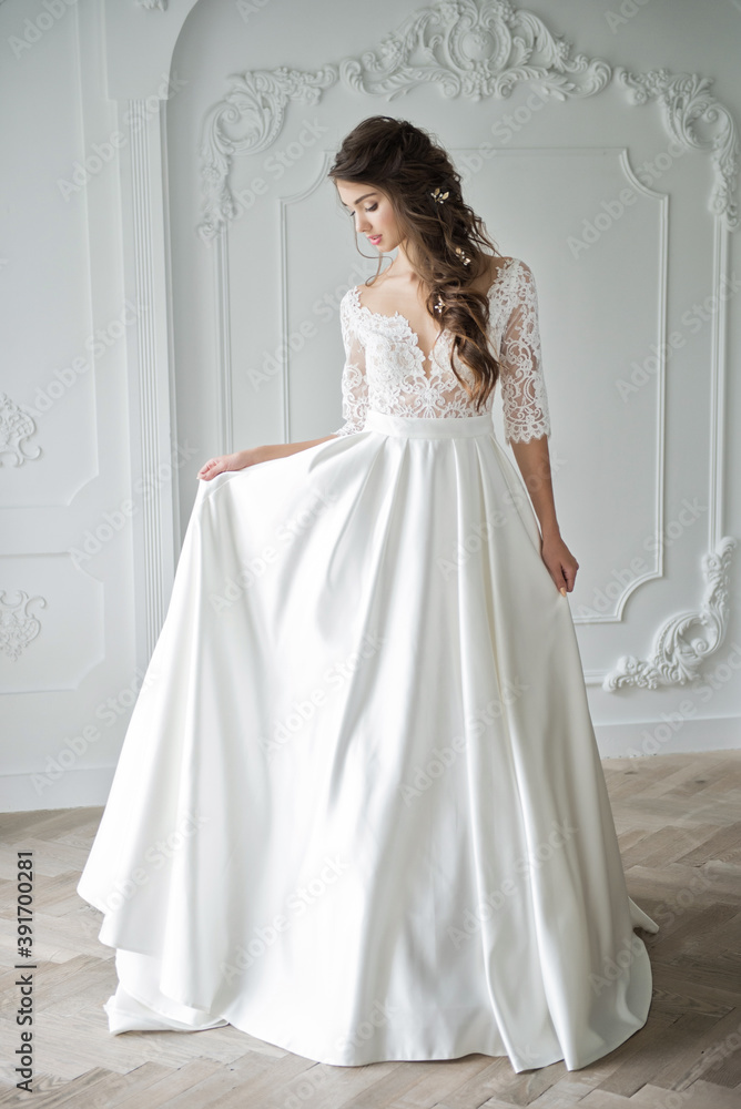 Portrait of a young bride in a fashionable wedding dress with beautiful makeup and hairstyle Portrait of a young bride in a fashionable wedding dress with beautiful makeup and hairstyle