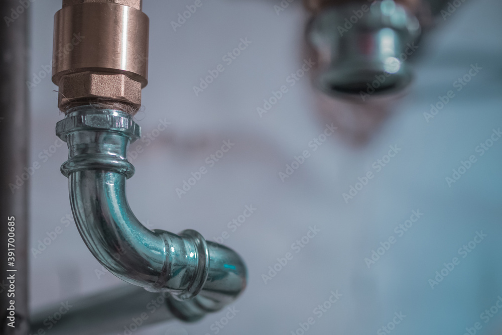 Detail of a metal heating pipe on a bend. Visible finished tube and place to crimp the tube. Detail of a metal heating pipe on a bend. Visible finished tube and place to crimp the tube.