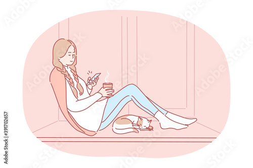 Comfortable relaxing at home with smartphone and hot drink. Young happy girl cartoon character sitting on windowsill with tea, chatting online on smartphone, enjoying rest at home near sleeping cat
