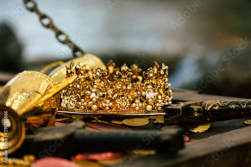 Antique treasure gold crown with coins for wealth , luxury and success concept