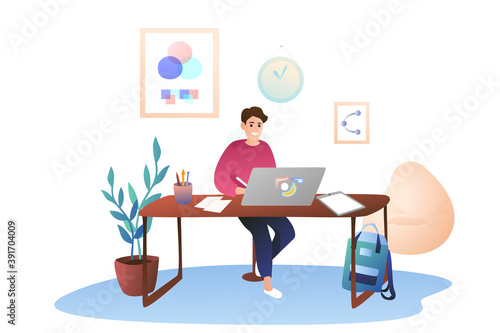 A young guy works at home using a graphics tablet. Work as a designer, remote work. Cozy modern office at home.