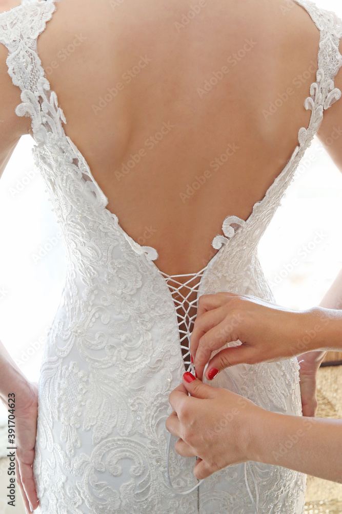 close up hands holding the bride's dress.