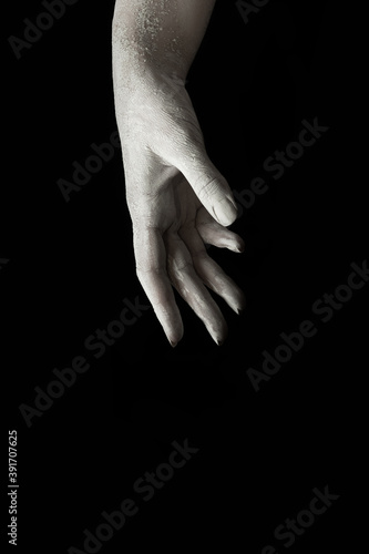 A beautiful female hand stretches your product on a black isolated background, concept art 