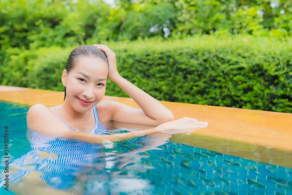 Portrait beautiful young asian woman relax smile around swimming pool