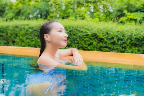 Portrait beautiful young asian woman relax smile around swimming pool
