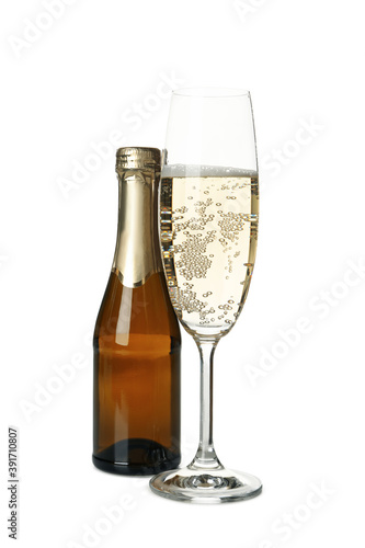 Glass and bottle of champagne isolated on white background
