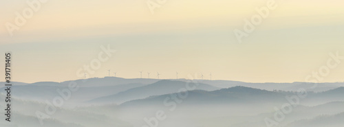 Wind power stations - wind turbines on the horizon, in the mountains, sky © Roman