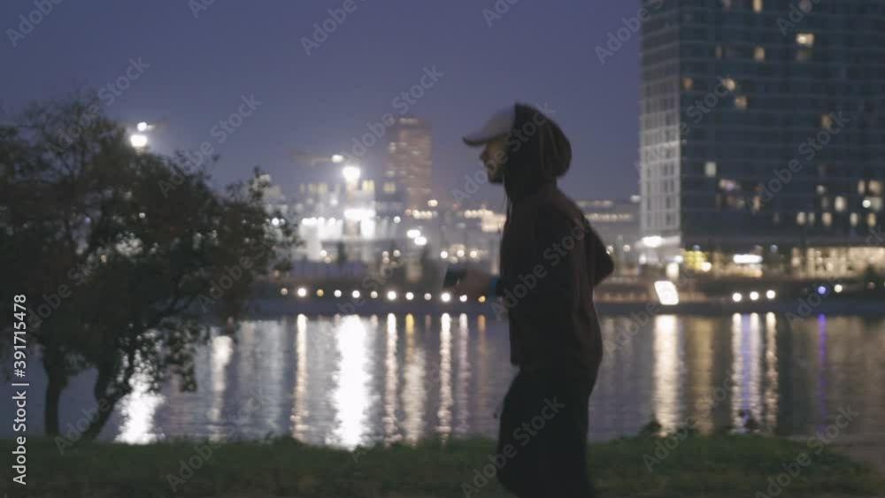 Athletic sporty man training in hoodie sweatshirt in urban city park.
Athletic sporty man training in hoodie sweatshirt in urban city park.