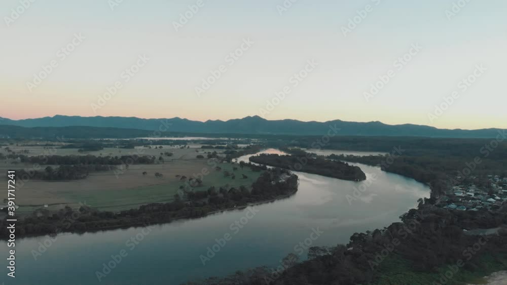 Backwards moving drone clip over the Bellinger river and towards the ocean in Myleston,Australia during sunset Backwards moving drone clip over the Bellinger river and towards the ocean in Myleston,Australia during sunset