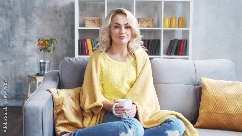 Young and attractive woman at home in the morning. Freelancer or student is drinking coffee. Young and attractive woman at home in the morning. Freelancer or student is drinking coffee.