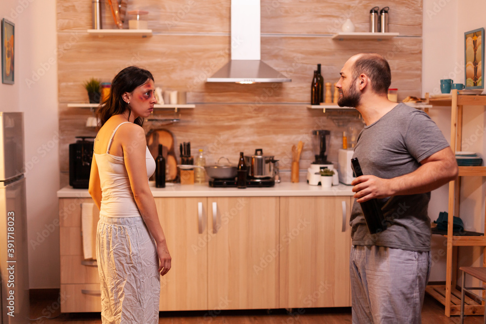 Violent husband screaming at abused housewife in dispair. Aggressive man abusing injuring terrified helpless, vulnerable, afraid, beaten and panicked woman living in terror and pressure Violent husband screaming at abused housewife in dispair. Aggressive man abusing injuring terrified helpless, vulnerable, afraid, beaten and panicked woman living in terror and pressure