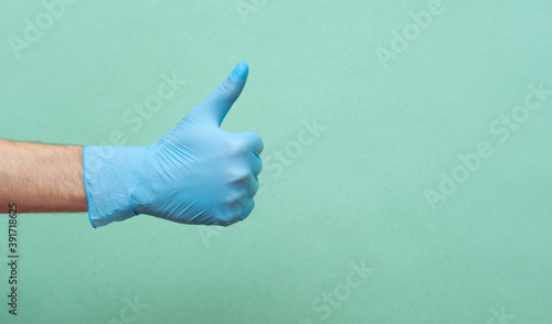 Doctor hand with glove showing like gesture or thumbup as approval, accept or done concept. Copy space. place for text