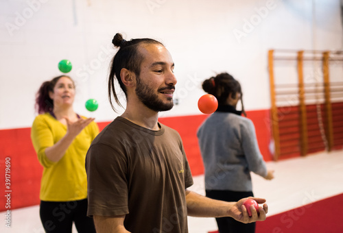 Man juggling balls in circus school.