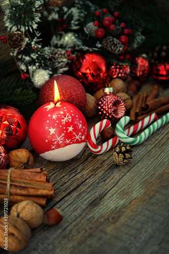 Christmas candle and festive decor on dark wooden background. Christmas and New Year concept. winter holiday season