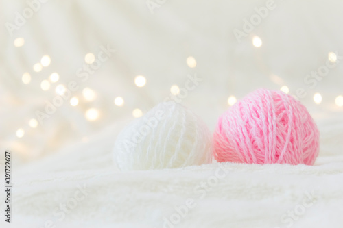 Balls of knitting thread lie on a light background.