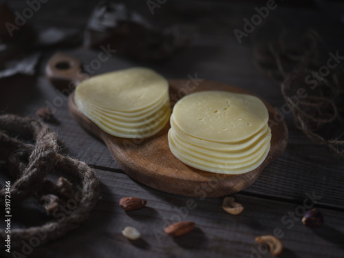 Sliced cheese and nuts on the table