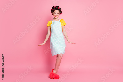 Full length photo of nice girl wear hair rollers clothes slippers isolated over pastel color background