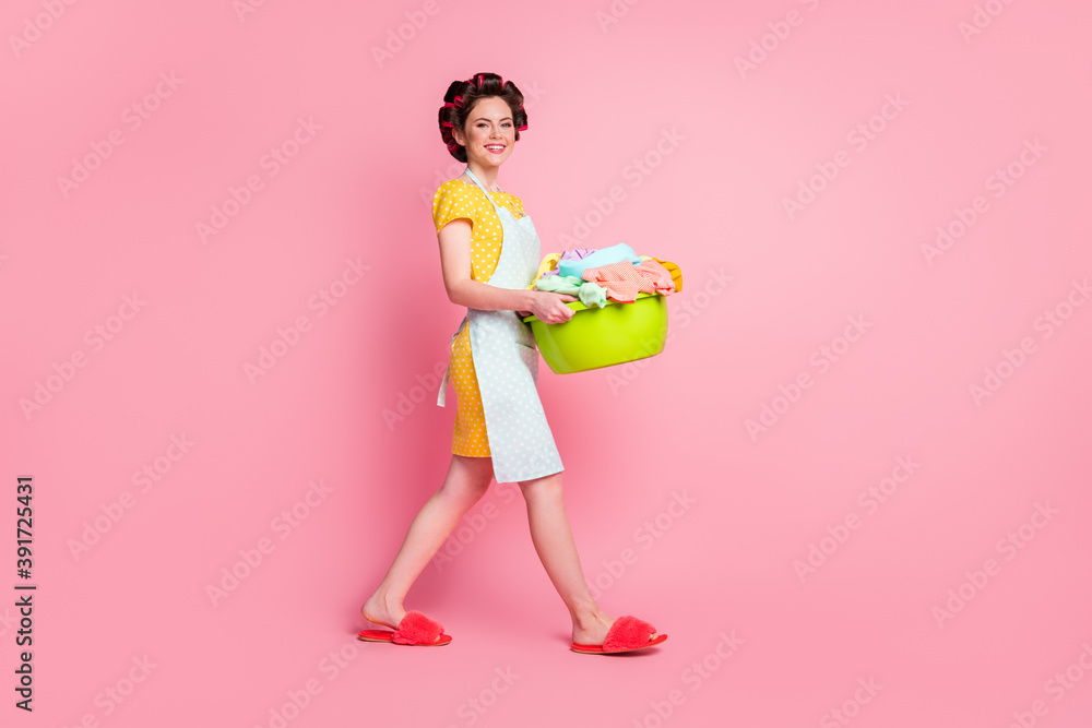 Full body photo of maid hold dirty basin go wear yellow skirt slippers isolated on pastel color background Full body photo of maid hold dirty basin go wear yellow skirt slippers isolated on pastel color background
