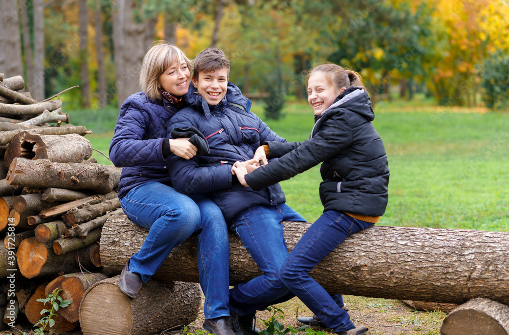 family relaxing outdoor in autumn city park, happy people together, parents and children, they talking and smiling, beautiful nature family relaxing outdoor in autumn city park, happy people together, parents and children, they talking and smiling, beautiful nature